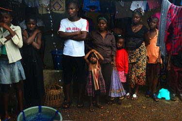 People line up to hear a Medecins sans Frontieres (MSF) worker give advice about Ebola and its dangers.  Sierra Leone is one of three countries severely affected by the Ebola outbreak in West Africa...