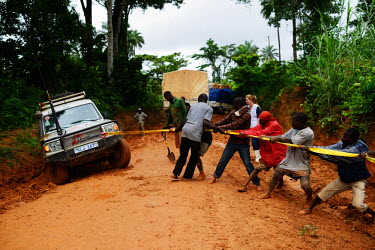 A vehicle belonging to Medecins sans Frontieres (MSF) is being pulled out of the mud by locals after having got stuck in the mud for few hours. The rainy season is making relief efforts even more diff...
