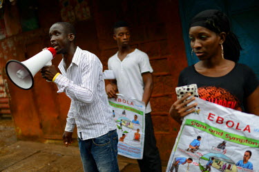 A group of volunteers speaks to locals, informing them about Ebola in a community in downtown Freetown , during the first day of the National lockdown.   The Sierra Leone government has declared a thr...