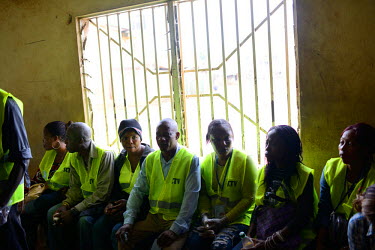 Volunteers meet to receive instructions at a health centre in the Kroo Bay slum area. People have been instructed to listen to police and volunteer workers who will pass through the slum, telling peop...