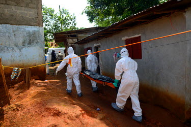 A burial team removes from a house the body of a suspected Ebola victim.  The Sierra Leone government has declared a three day lockdown from 19 September in an attempt to prevent the further spread of...