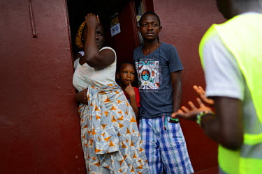 A group of volunteers speaks to locals, informing them about Ebola in a community in downtown Freetown , during the first day of the National lockdown.   The Sierra Leone government has declared a thr...