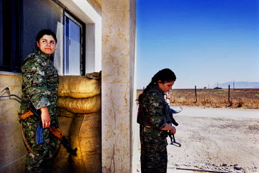 Women guarding the entrance to the YPJ's (Women's Protection Unit) compound. The YPJ is a Kurdish female militia fighting the Islamic State and Jabhat al-Nusra in the primarily-Kurdish north. Around 3...