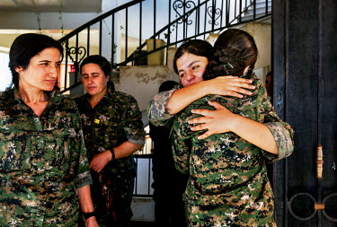 Comrades welcome each other, after returning from the front lines, at the YPJ's (Women's Protection Unit) compound. The YPJ is a Kurdish female militia fighting the Islamic State and Jabhat al-Nusra i...