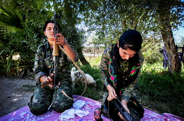 Female soldiers, from the YPJ (Women's Protection Unit), maintain their rifles. The YPJ is a Kurdish female militia fighting the Islamic State and Jabhat al-Nusra in the primarily-Kurdish north. Aroun...