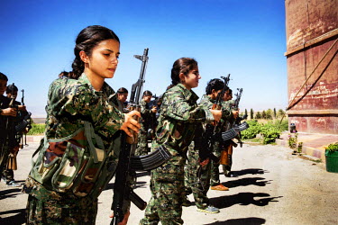 Female soldiers, from the YPJ (Women's Protection Unit), parade with their weapons. The YPJ is a Kurdish female militia fighting the Islamic State and Jabhat al-Nusra in the primarily-Kurdish north. A...