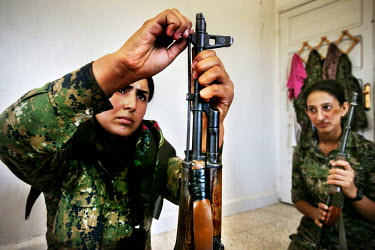 Female soldiers, from the YPJ (Women's Protection Unit), maintain their Kalashnikov rifles. The YPJ is a Kurdish female militia fighting the Islamic State and Jabhat al-Nusra in the primarily-Kurdish...