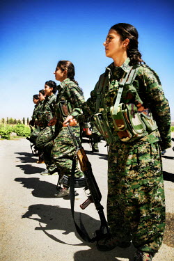 Female soldiers, from the YPJ (Women's Protection Unit), parade with their weapons. The YPJ is a Kurdish female militia fighting the Islamic State and Jabhat al-Nusra in the primarily-Kurdish north. A...