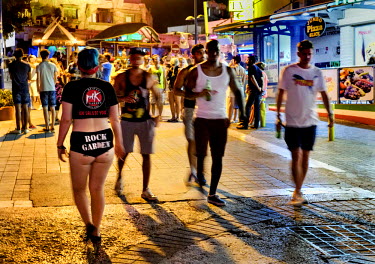 People walking in Agia Mavri Street, known for its many bars.