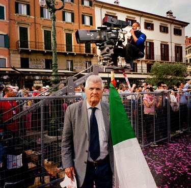 A cycling fan holding a big Italian flag near the finish for that day's stage of the Giro d'Italia.