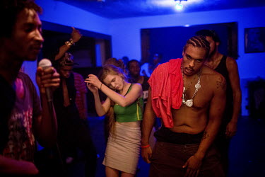 Young people dancing to hip hop music being played at a house party.