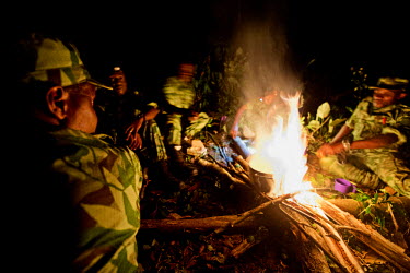 Eco guards cook dinner over an open fire while on patrol in a logging concession outside the Minkebe National Park.