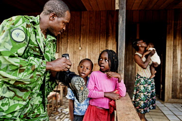 Park ranger (ecoguard), Soho Jocelyn, polishes his boots before leaving his family and go on patrol in Minkebe National Park. Being a ranger in Central Africa has become increasingly dangerous as poac...