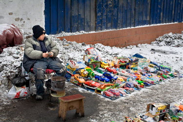A Uyghur boy, selling Chinese-made toys from a street-side stall, counts the day’s takings. The fast economic growth of Xinjiang, resulting from extensive extraction of natural resources, is not not...