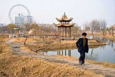 Uyghur boy walks through Lake Park, built in the Han Chinese style for the numerous Han 'pioneers'.
