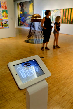 A family visiting the ARoS Aarhus Kunstmuseum. Information about exhibits is displayed to visitors on tablet computers.