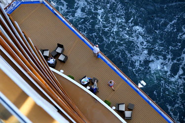 A view down from the 16th deck to tourists on board a luxury cruise liner. These vast ships carry thousands of passengers and thousands more staff to cater for their every need. Tourism in the Baltic...