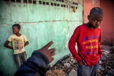 Peterson (12, right), a 'restavek' ran away from his master after the 'gudu-gudu' (the Creole name for the 2010 earthquake), because she would beat him almost every day. He lives on the street with a...