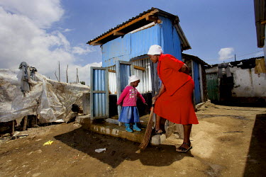 Eunice, the co-founder of Kasarani Academy,  with a child in front of the school latrines built especially for their pupils. Previously, the school only had 2 toilets which were used by 250 pupils. Te...