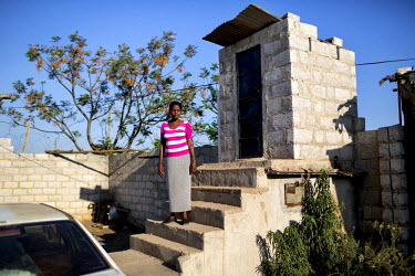 Jessy Mupasha (44) outside the toilet at her home in Kanyama. Due to the rocky nature of the land in Kanyama (Dolomite) it is impossible to dig holes in the ground. Toilets are therefore built up. The...