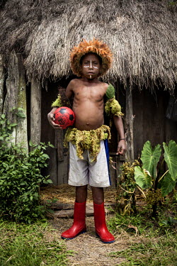 Abinus Kuban, 10, holds a ball which he and his friends play with. The children from his village, Arigaram, wear secondhand clothes on a day-to-day basis but wear 'kotekas' (gourd penis sheaths) for c...