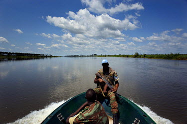 A UNHCR/IEDA team are accompanied down the Luvua River by armed UN peacekeepers after researching human rights violations at Kasonsa village. The journey to Kasonsa was riddled with logistical challen...