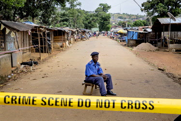 Police sergeant Alimamy Kamara, 53, on guard duty in the village of Grafton where 47 households on the main street have been put into quarantine after at least 17 cases of ebola were reported. Officia...
