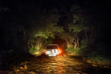 A UN peacekeeper's vehicle drives through a difficult stretch of flooded road at night during a trip researching human rights violations at Kasonsa village. The journey to Kasonsa was riddled with log...