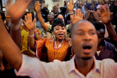 Mary Koroma, 30, participating in a Sunday service at the Winners' Chapel International, a Christian church in central Freetown. The Sierra Leonean authorities have demanded that crowds of people shou...