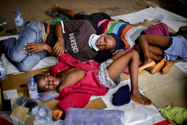 Eight members of the Fofana-Kamara family, who have become ill with ebola-like symptoms, lie on the ground waiting outside the Connaught Hospital in hope that they will soon be tested and receive trea...