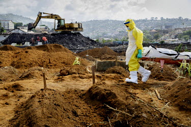A burial, at the King Tom cemetery, of a person who is suspected to have died from ebola into one of a group of pre-dug graves. Due to the rapid increase in burials, caused by the ebola crisis, the ce...