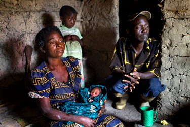 Newborn baby boy Kabila is held by his maternal grandmother, Kabulo Ilunga, three hours after his birth at the family's shelter at the Kanteba IDP site. Kabila's family fled their home village to esca...