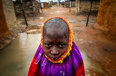 Kibowa, 10, stands between two recently-erected shelters at the Kanteba IDP site. Kibowa and his family fled their home village to escape violence caused by the Mai Mai Bataka Katanga rebel militia.Du...