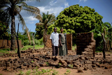 Pastor Mokoyo Jean, 42, and his wife Wilambwe Antoinette, 35, stand amid the ruins of their home in Kasonsa village, where hundreds of houses were burned in July during inter-communal clashes. Locals...