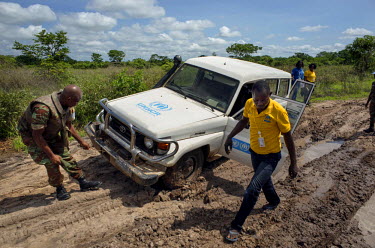 A Beninois peacekeeper assists the UNHCR/IEDA team to get their vehicle unstuck while en route to research human rights violations at Kasonsa village, far up the Congo and Luvua Rivers. The journey to...