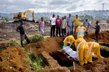 Relatives attend the funeral, at the King Tom cemetery, of a person who is suspected to have died from ebola. Due to the rapid increase in burials the cemetery is being enlarged and parts of a nearby...