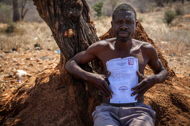 Witchdoctor Ropinho Cassuada displays his certificate from the Mozambican traditional healer's association AMETRAMO, which permits him to practice traditional healing activities in the country.