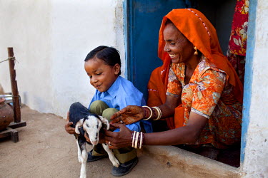 Suki's (not her real name), mother plays with her grandchild at their house in Jhaju village. Now 20, Suki was married the age of 12, but only went to live with her husband when she was 14. She, and h...