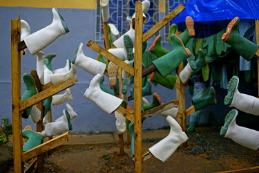 Rubber boots drying at the entrance of an MSF transit centre for Ebola patients , near the border with Liberia.