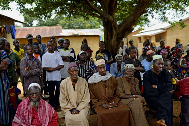 Elders of the village of Dzomankoidu meet with members of the Red Cross at the main square in the village. Prior to this negotiated visit by the Red Cross the villagers had denied the existence of the...