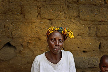 Wata Kamara cries as she sits at the door of her house after one of her children, Siafa Sherif (8), and her husband, Sekou Sheri,f both with ebola symptoms were transfer to an MSF treatament centre in...