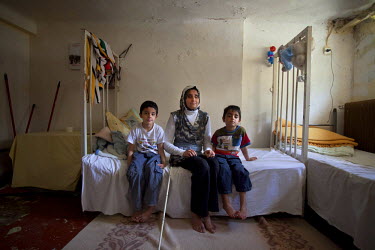 Thirty four year old Jihan with her sons Ahmed and Mohammad aged five and seven in the Lavrio refugee camp. They left Damascus with her husband Ashraf, to escape the conflict. Both husband and wife ha...