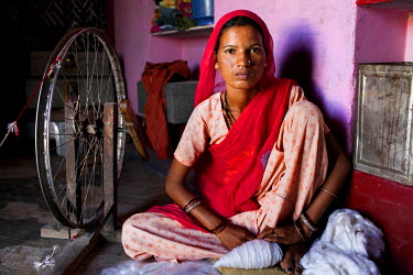 Suki (not her real name), nest to her spinning wheel iat her house in Jhaju village. Now 20, Suki was married the age of 12, but only went to live with her husband when she was 14. She, and her two si...
