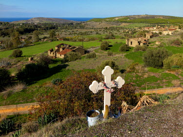The grave of a man who died in 2004 overlooks the deserted village of Agios Nicolaos, from where its Greek Cypriot inhabitants fled in 1974. It is now in the UN Buffer Zone that separates the Greek an...