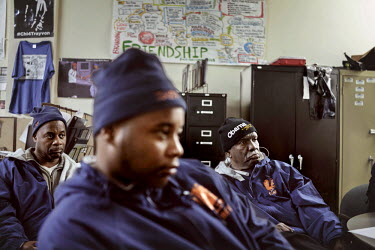 Former gang members have gathered in the local office of Cure Violence in Englewood to plan the evening. Every day, they walk and drive around the streets, talking to gang members and trying to preven...