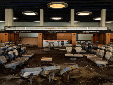 Seating, passport and visa booths at the arrivals terminal in the disused international airport. It opened in 1968 and has been deserted since the Turkish invasion of 1974. It now sits in the Buffer Z...