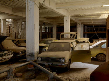 Decaying cars, abandoned in the underground carpark beneath Maple House a shopping centre on the 'Green Line', a buffer zone, that divides Turkish Northern Cyprus and Greek Southern Cyprus, establishe...