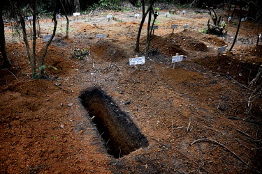 A freshly excavated grave in a graveyard behind the Ebola Treatment Unit in Bong. Phoebe (6) and Mary (15 months) are two girls from Taylor Town in Bomi County who grew up together. Phoebe's brother w...