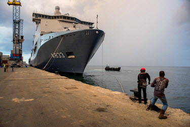 Dock workers secure mooring lines as the Dutch navy ship, the Karel Doorman, arrives in freetown. The ship and its crew have come to offer assistance during the ebola crisis.