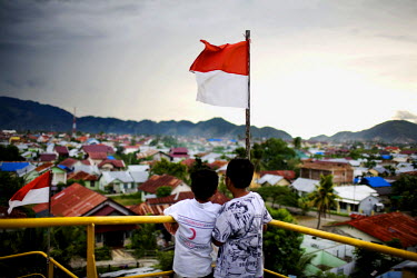 Two boys look out from the deck of a 2,600-ton ship which was carried two miles inland by the 2004 tsunami and remianed stranded when the waters receded. A new city park has been built around the ship...